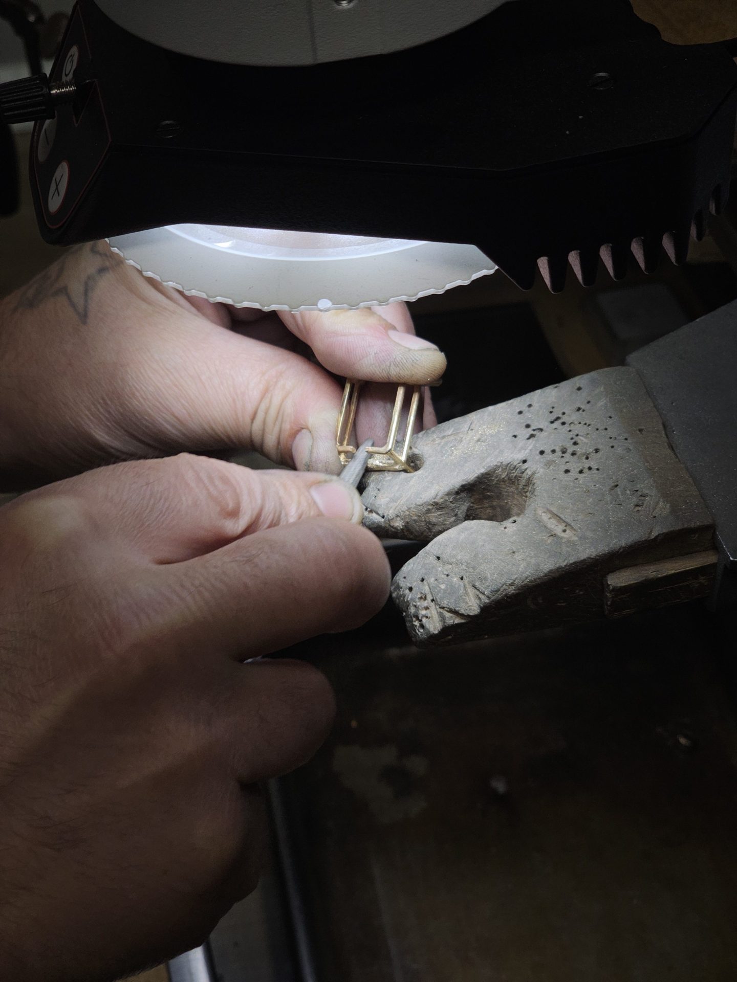Laevi's hands crafting jewelry